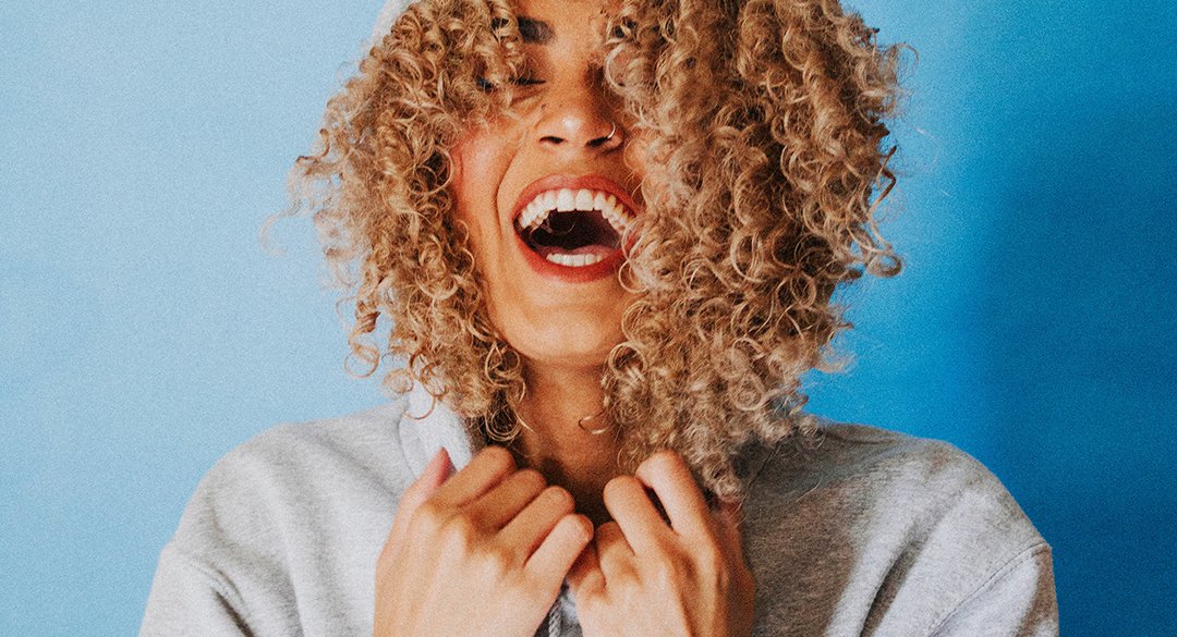 Woman smiling and holding her collar