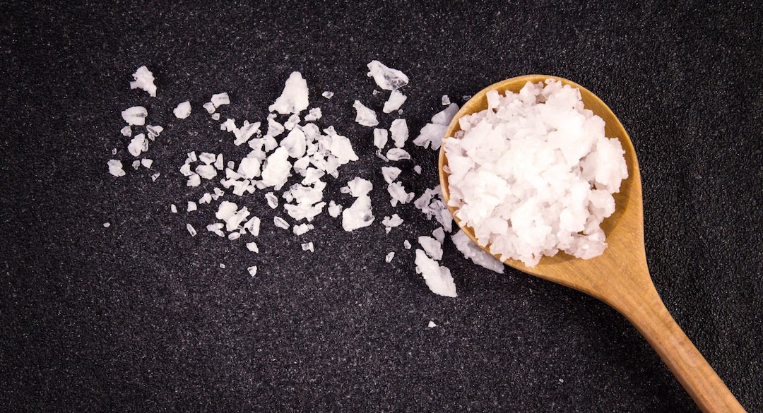 Wooden spoonful of rock salt