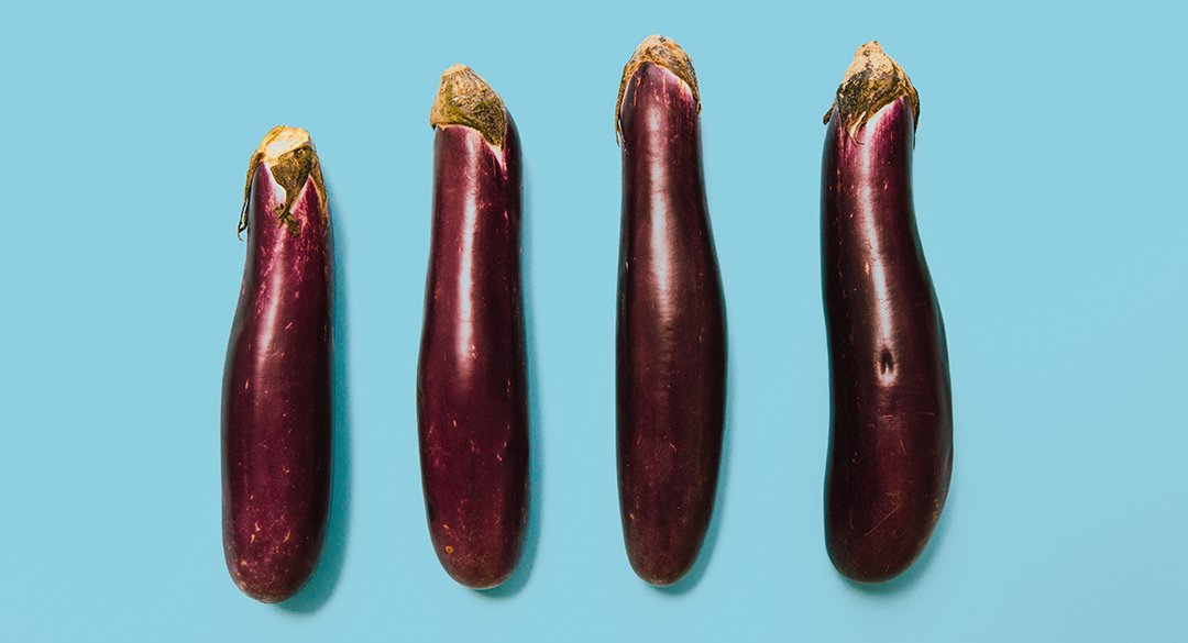 Four eggplants on a blue background