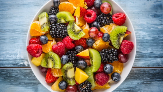 A bowl of fruit salad with citrus and berries-1.png
