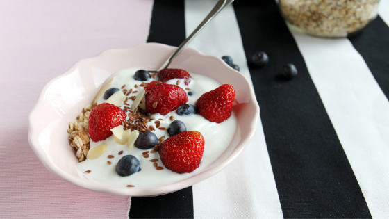 A bowl of lowfat yogurt topped with berries-4.png