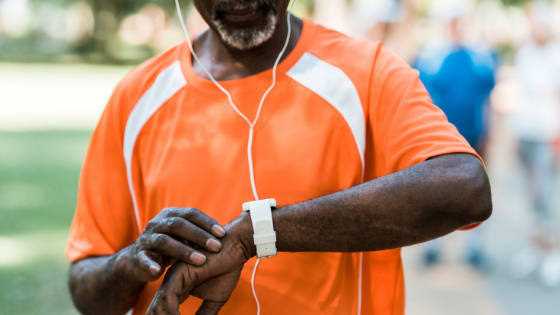 A close up of a man checking his miles on his smart watch while running in the park-8.png