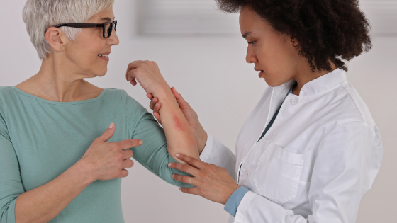 A dermatologist inspects a rash on a senior woman's arm-3.png