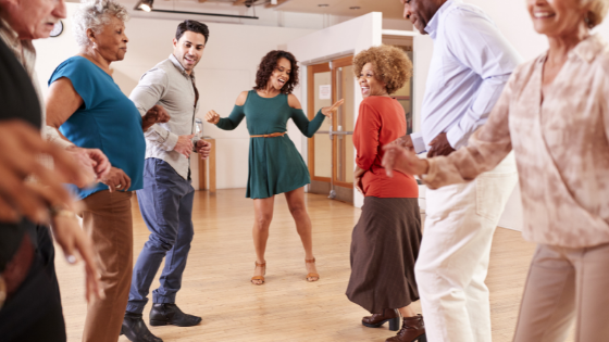 A group of seniors is seen taking dance lessons from an insturctor-3.png