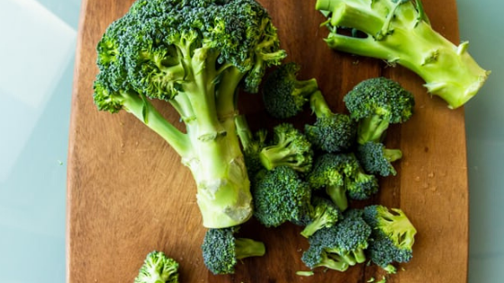 A head of broccoli sits on a cutting board being chopped-3.png