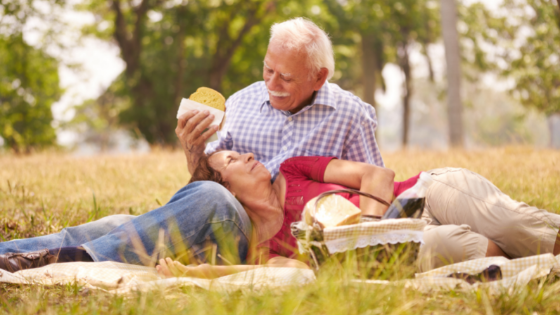 A loving senior couple enjoy a spring picnic outdoors-8.png