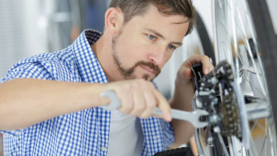 A man is seen tightening the wheels on a wheelchair-4.png