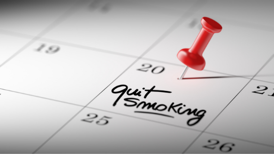 A red thumbtack pierces a calendar with 'quit smoking' written on the 20th of the month-5.png