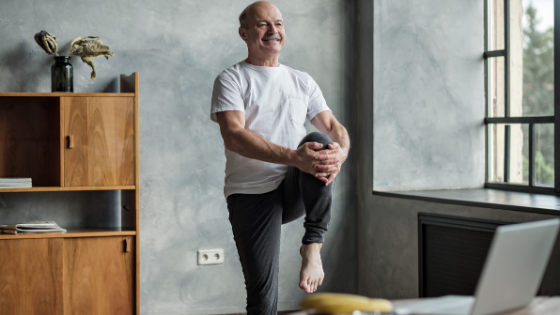 A senior man is seen holding his knee into his chest balancing on one leg-6.png