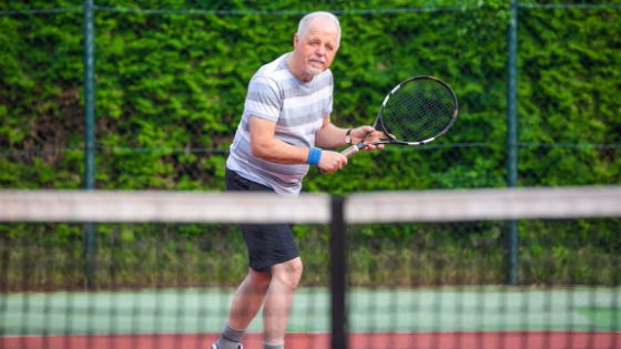 A senior man is seen playing tennis-1.png