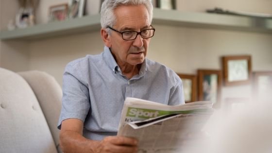A senior man is seen sitting reading the paper-1.jpeg