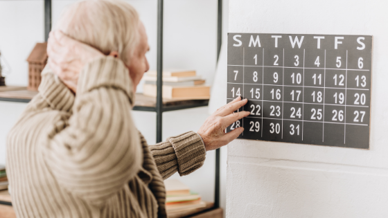 A senior man looks confused as he stares at a calendar-3.png