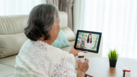 A senior woman holds up her prescription while on a video visit with her doctor-1.png