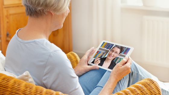 A senior woman is seen on a video call with her doctor sitting comfortably in an armchair-3.png