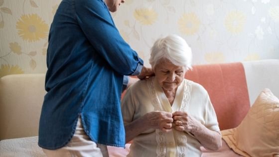 A woman is seen helping an elderly woman get dressed-7.jpeg