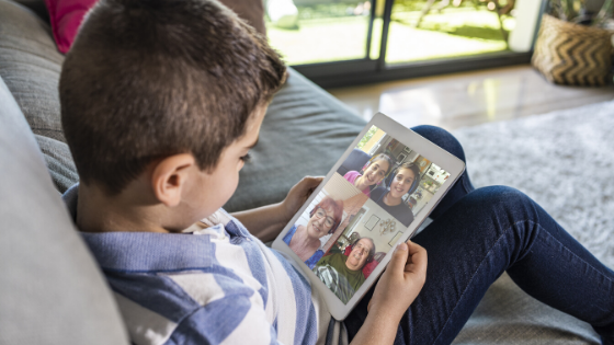A young boy is seen FaceTiming with grandparents and other family-1.png