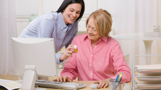 A younger woman helps a senior woman to refill her prescriptions online-9.png