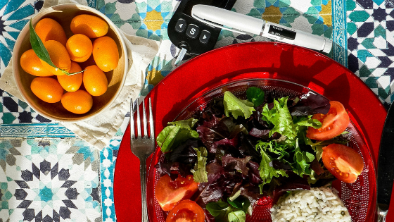 An insulin pen next to a plated salad-4.png