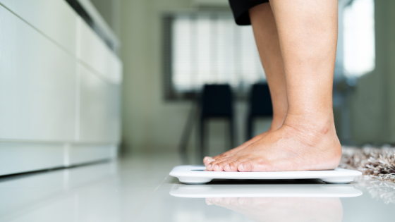 An older person's feet can bee seen standing on a scale-7.png
