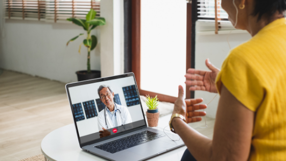 An older woman is seen having a virtual visit with her doctor on her laptop-9.png