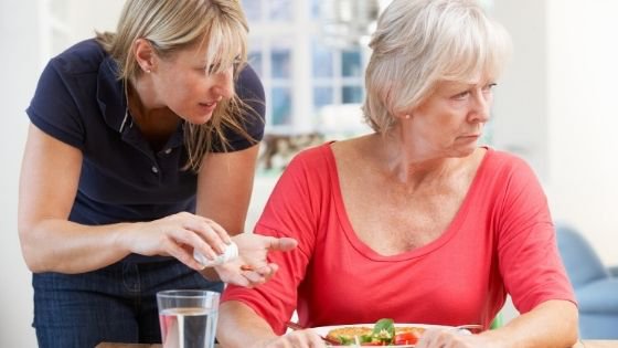An older woman looks away, upset while a younger woman tries to care for her-9.jpeg
