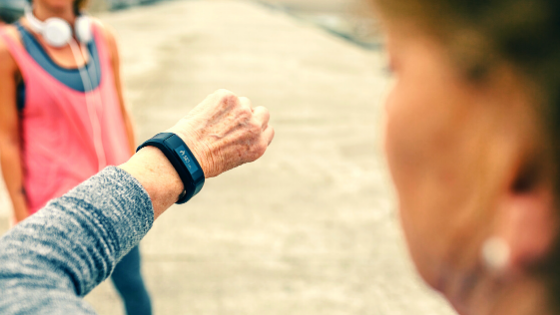 An older woman on a run with a friend stops to check her heart rate-5.png