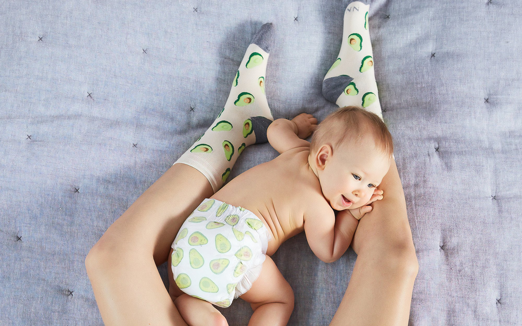 Baby playing on mom's legs.jpg