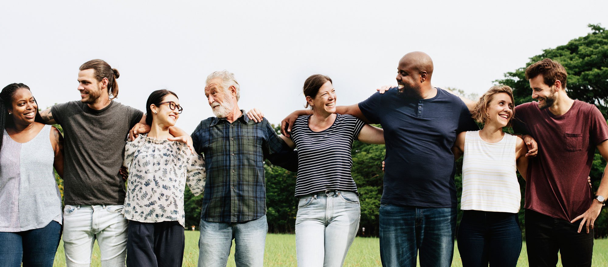 People standing in a row hugging