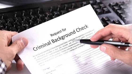 Close up of a person reviewing a paper background check request form-6.jpeg