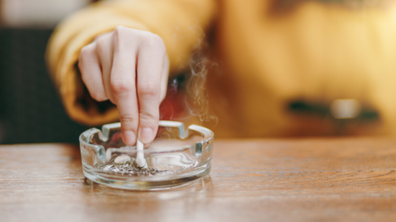 Close up of a woman extinguishing a cigarette in an ashtray-3.png
