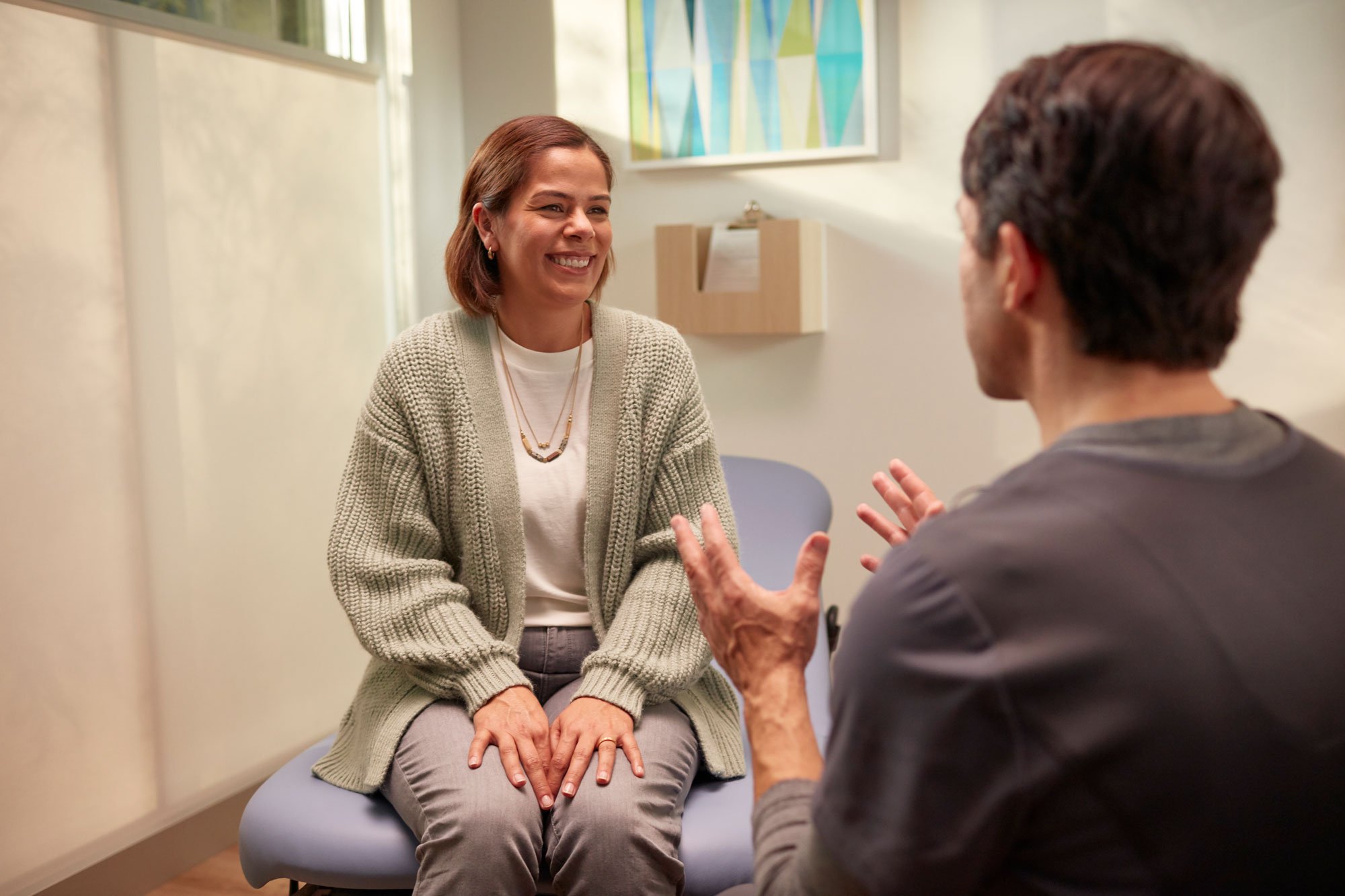 Woman in primary care office exam room