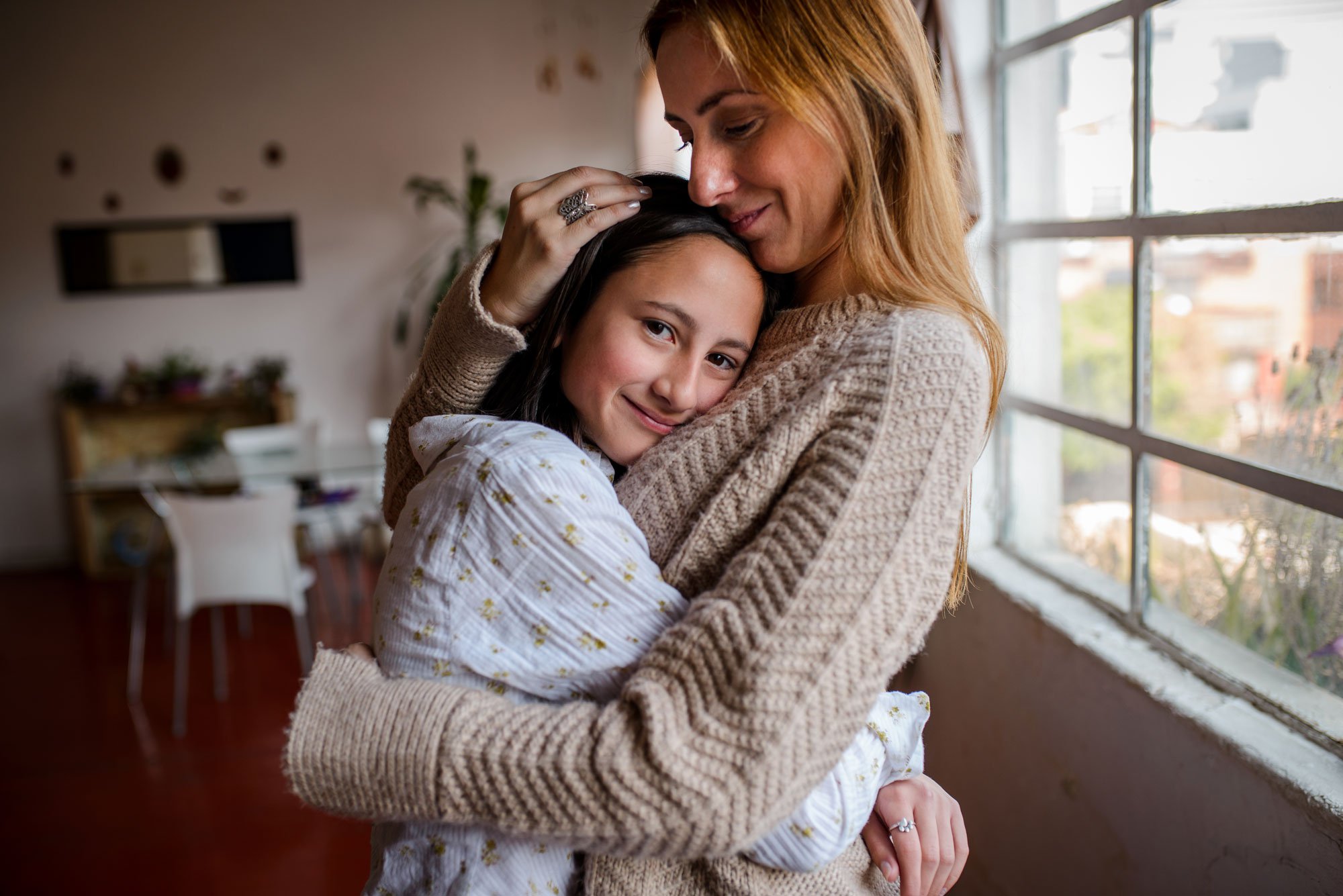 Mom hugging daughter