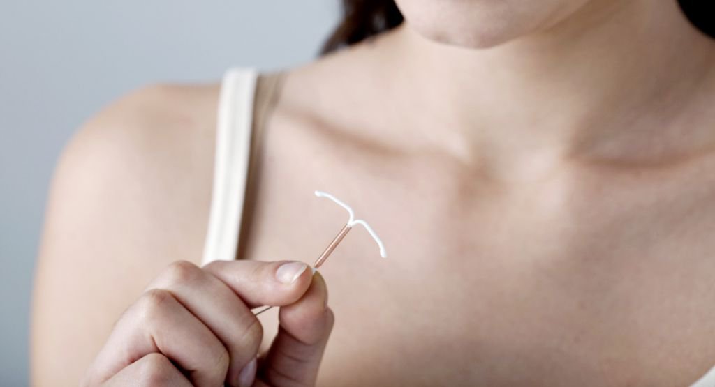 Woman holding an IUD
