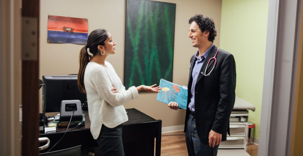 Provider and woman talking in an exam room