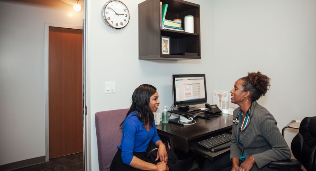 Doctor and patient consulting with one another at a desk