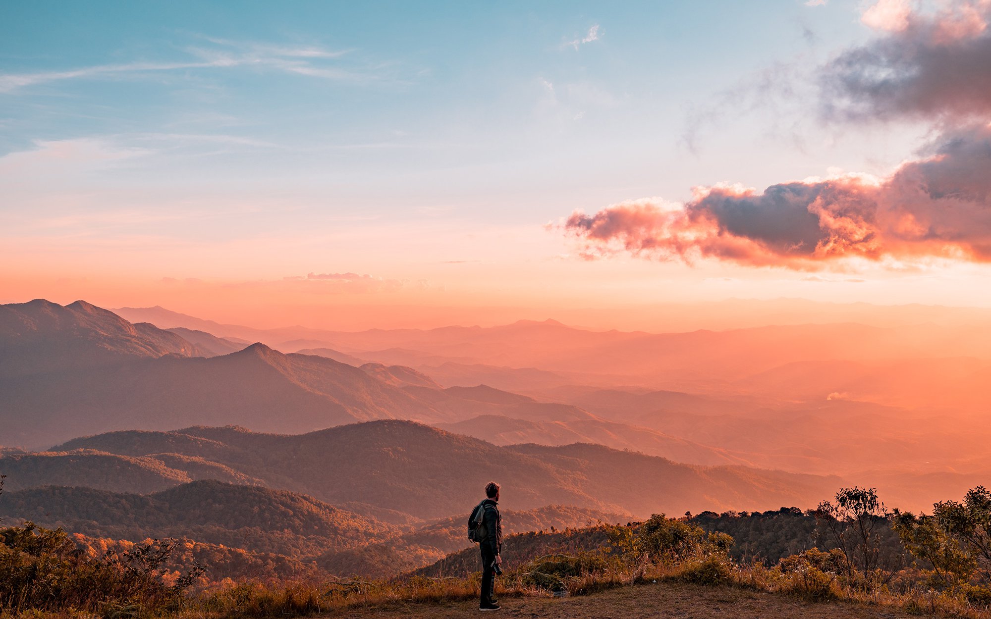 Man looking at mountain range in distance