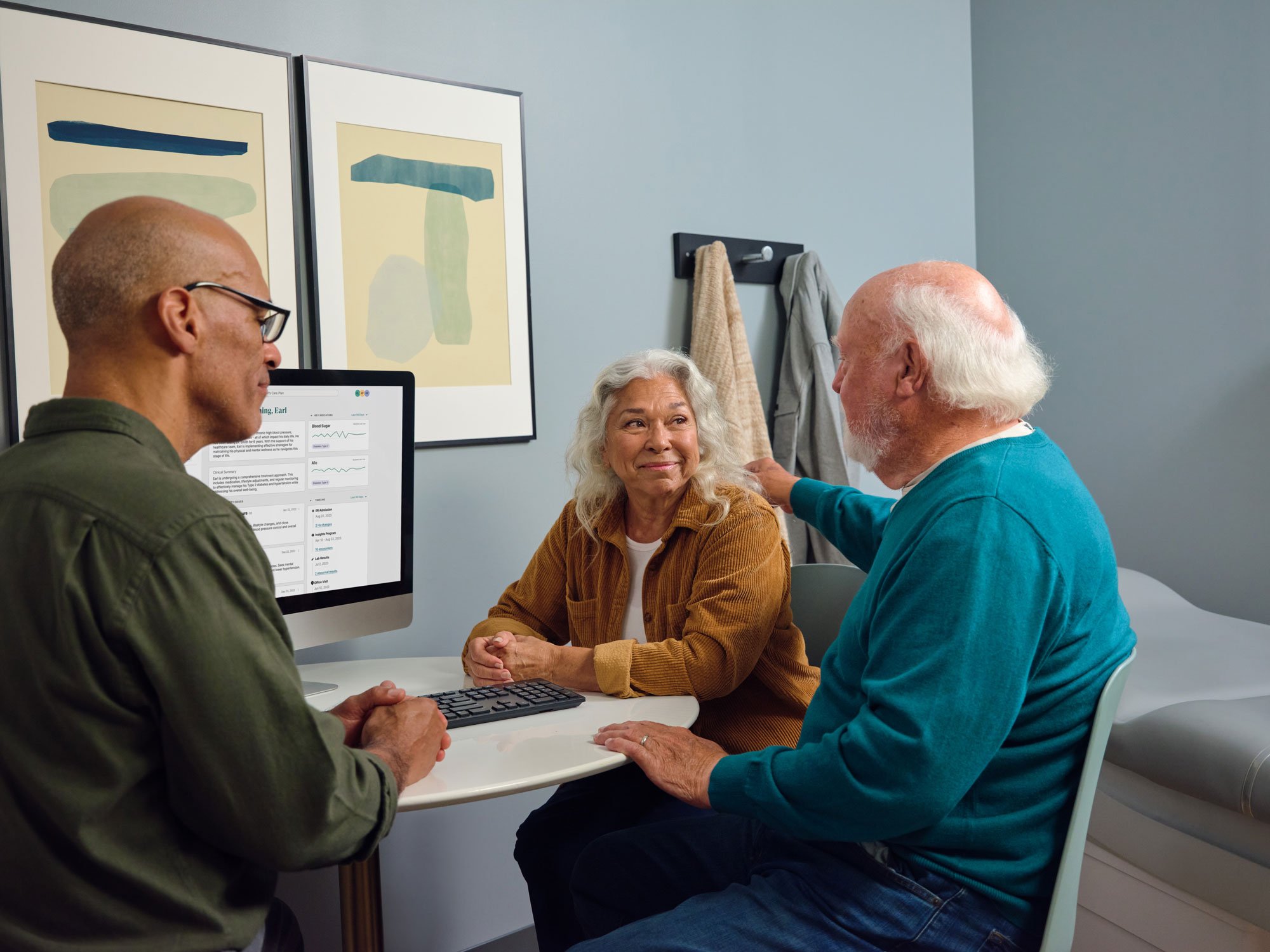 Older couple talking to their One Medical provider in an exam room