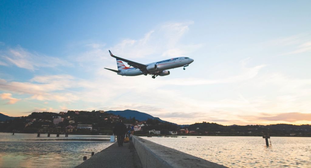 Airplane taking off over water