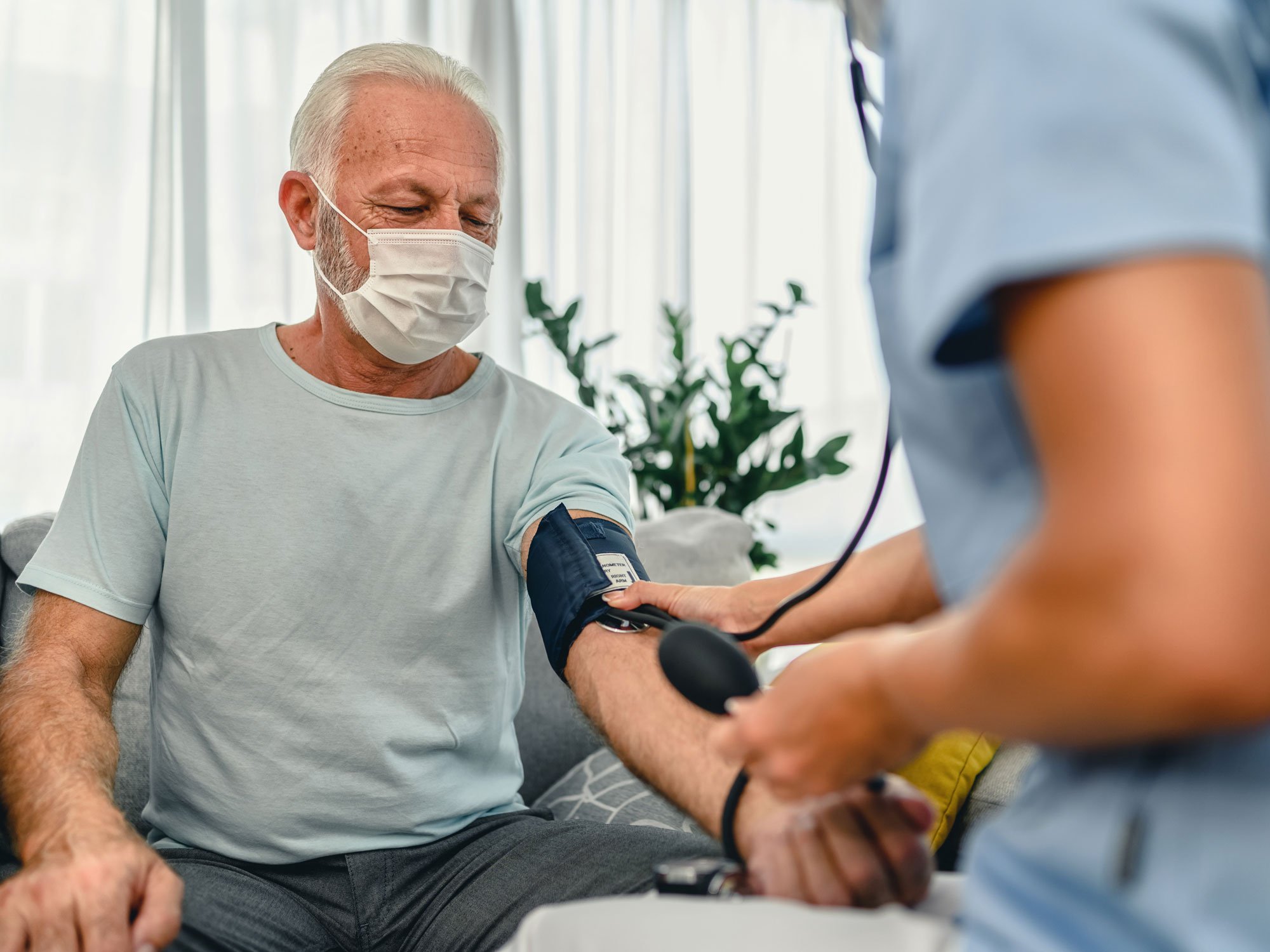 Man getting his blood pressure taken by a nurse.