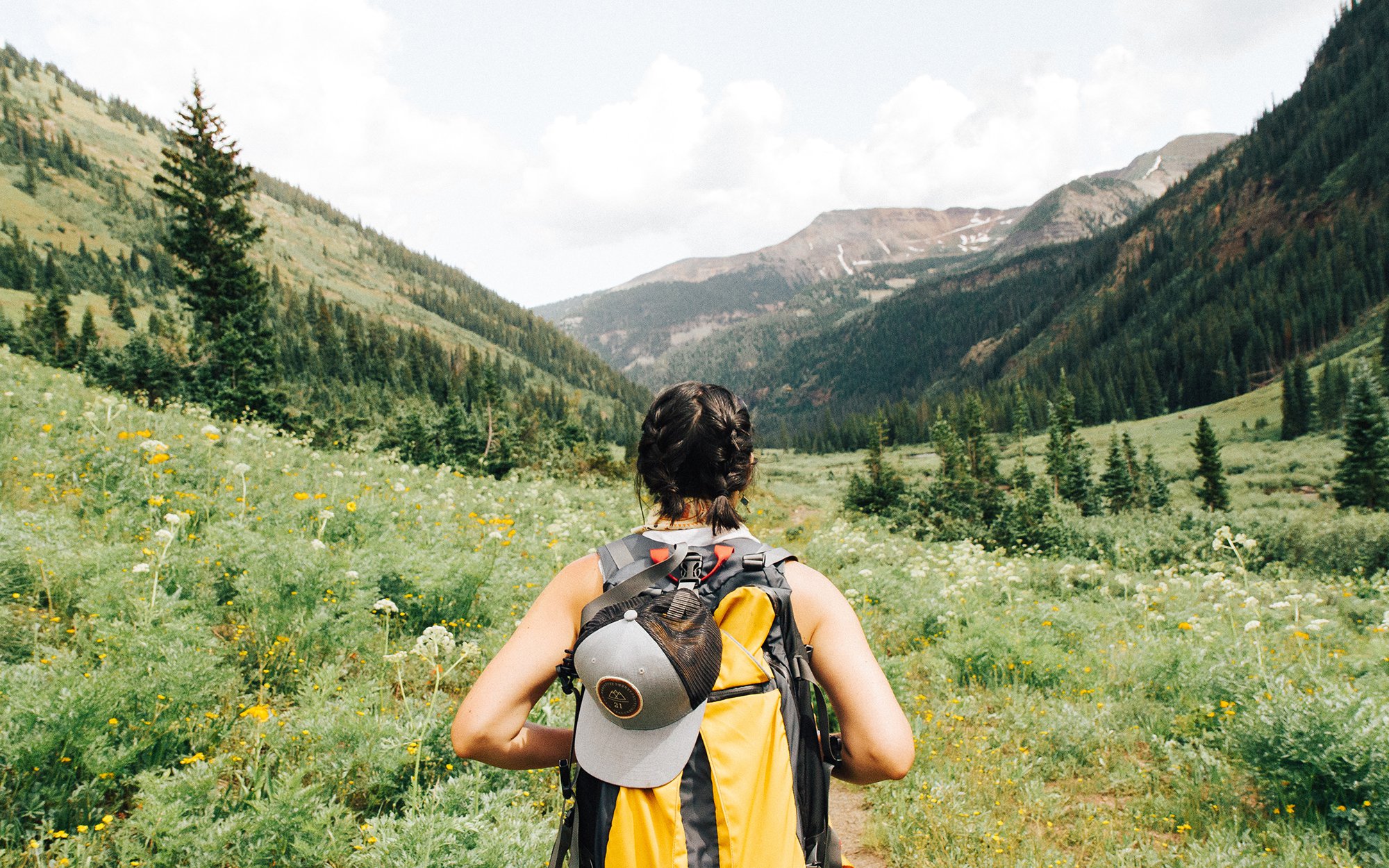 Woman hiking in tall grass.jpg