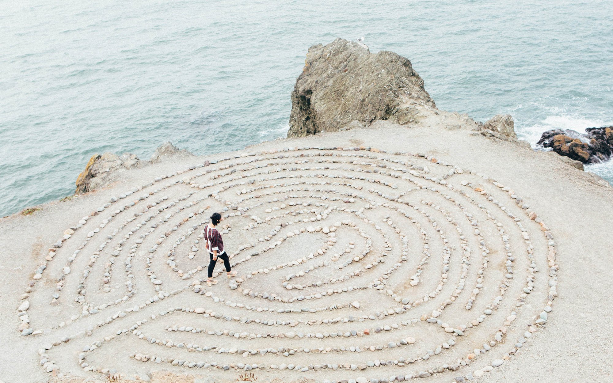 Woman walking through zen garden