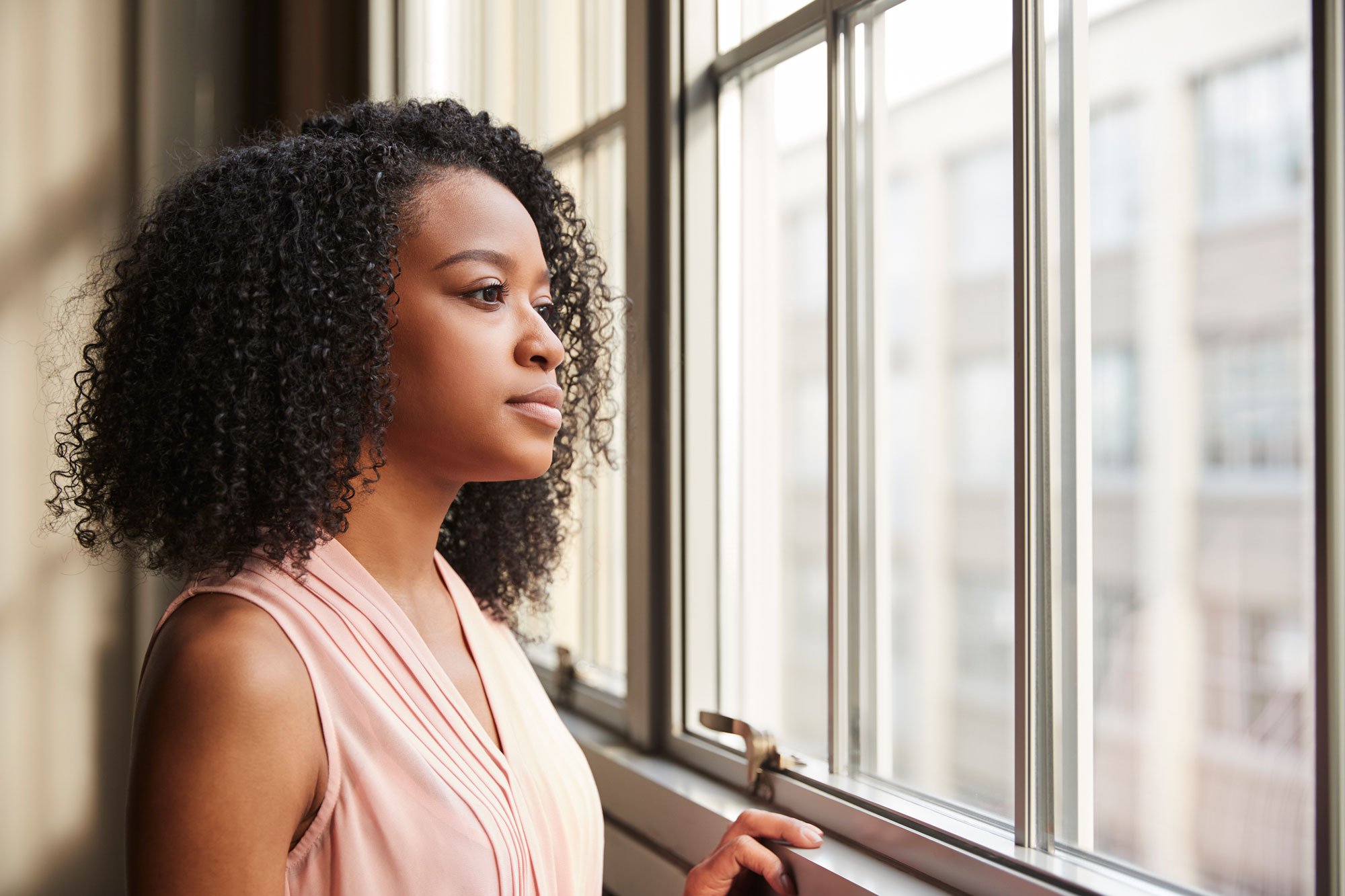 Woman starting pensively out window