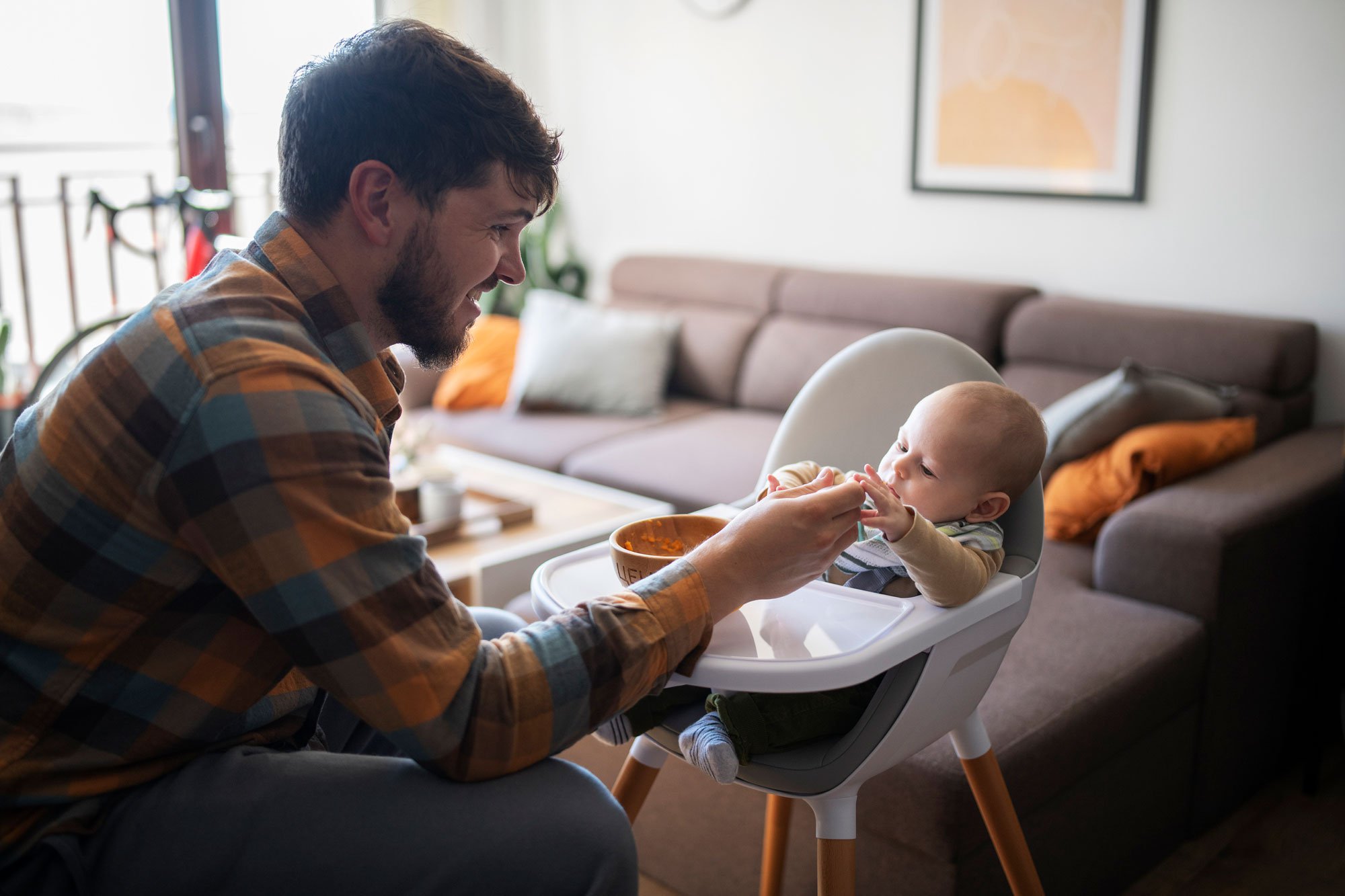 Dad feeding his baby with a spoon