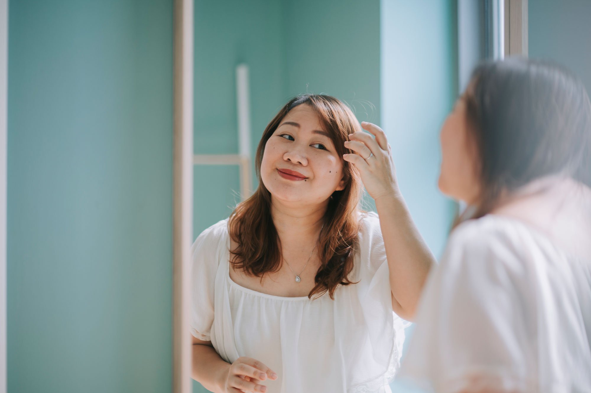 Woman looking at herself in the mirror