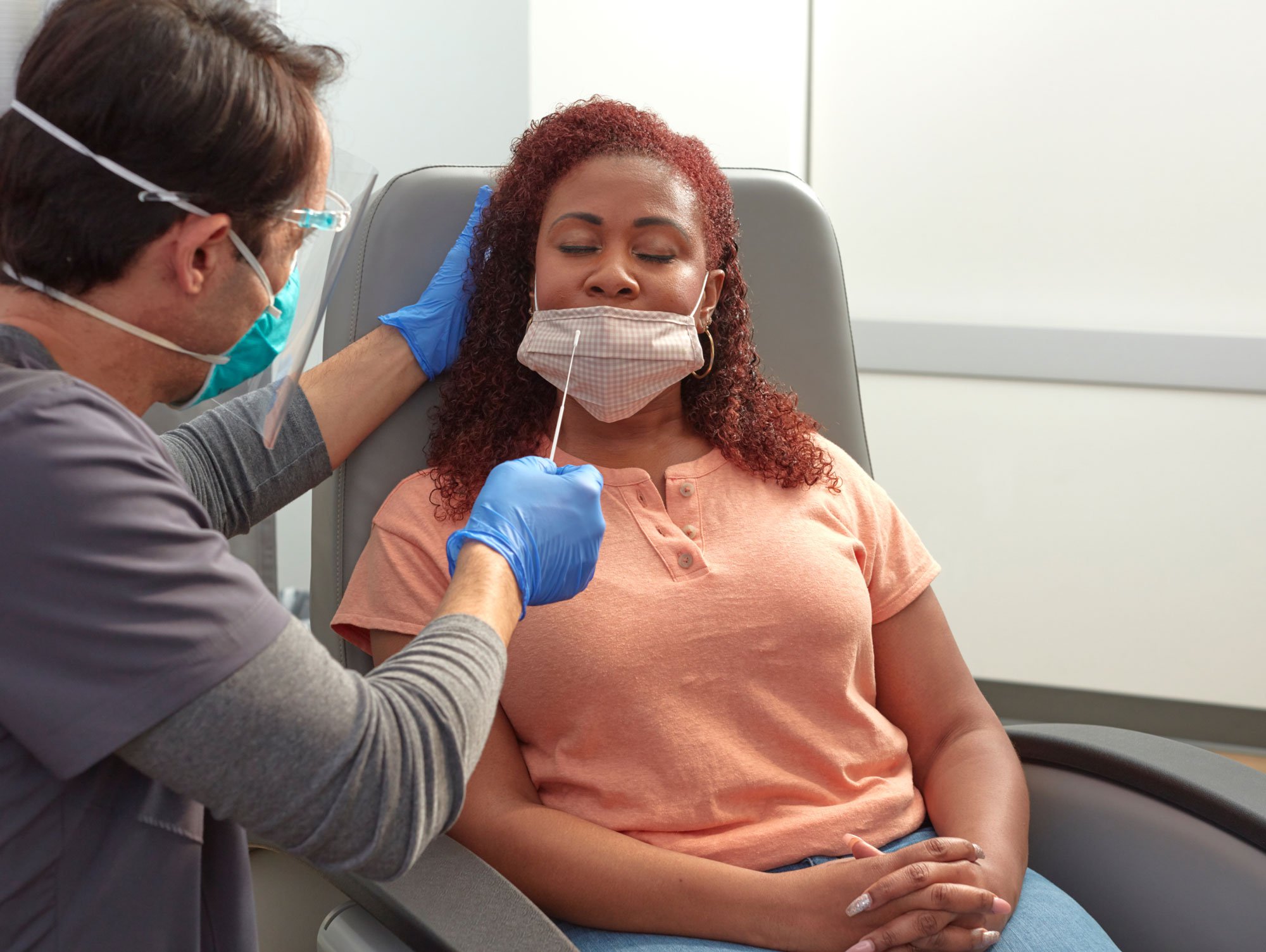 Photo of a patient receiving a COVID-19 test with nose swab.