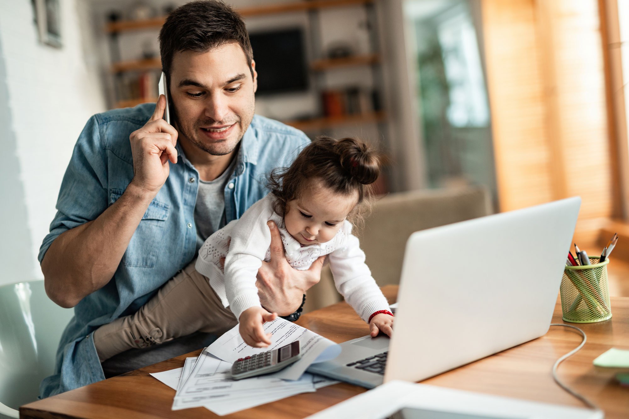 dad-holding-daughter-on-phone.jpg