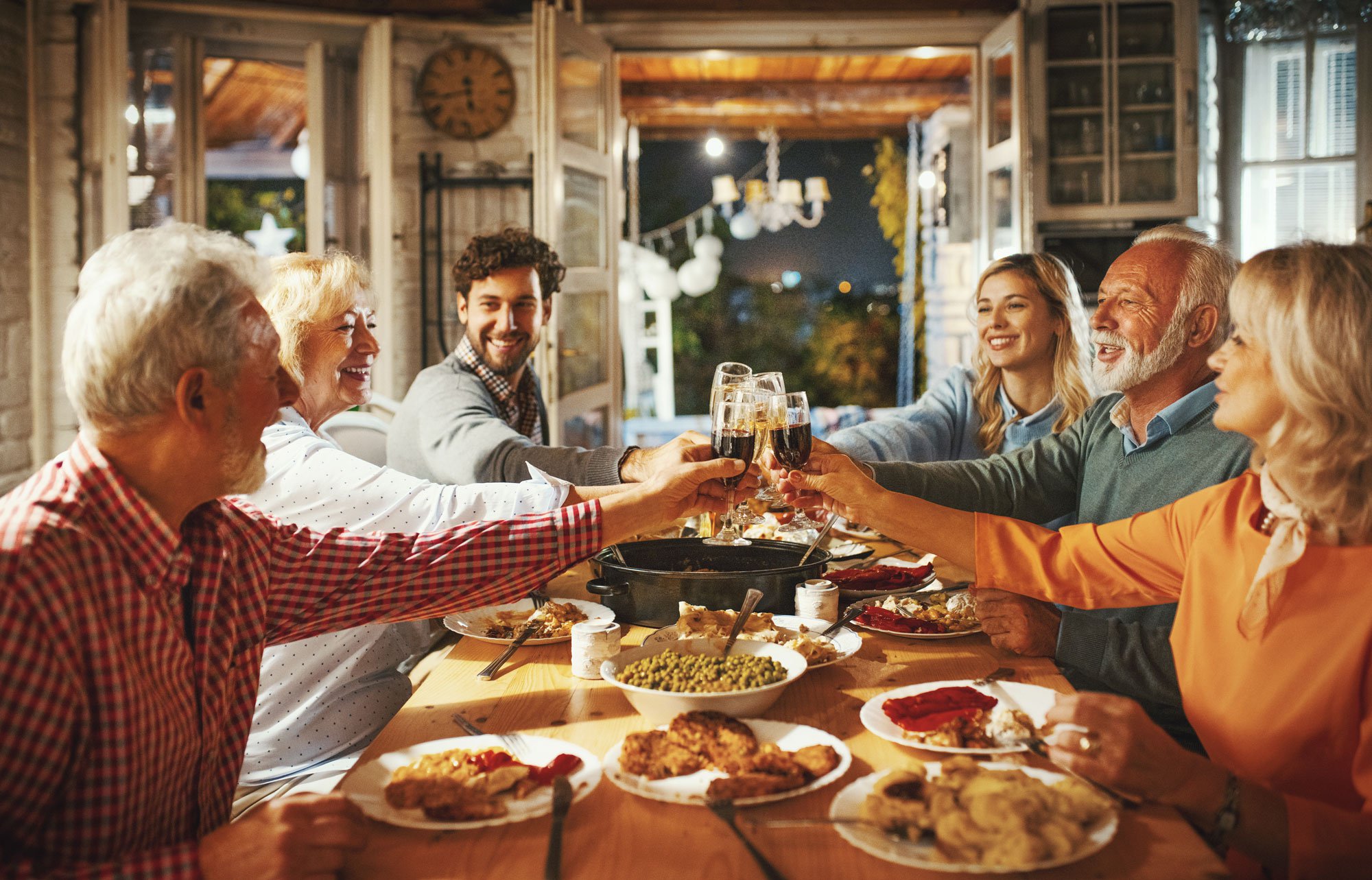 Family cheersing over thanksgiving feast