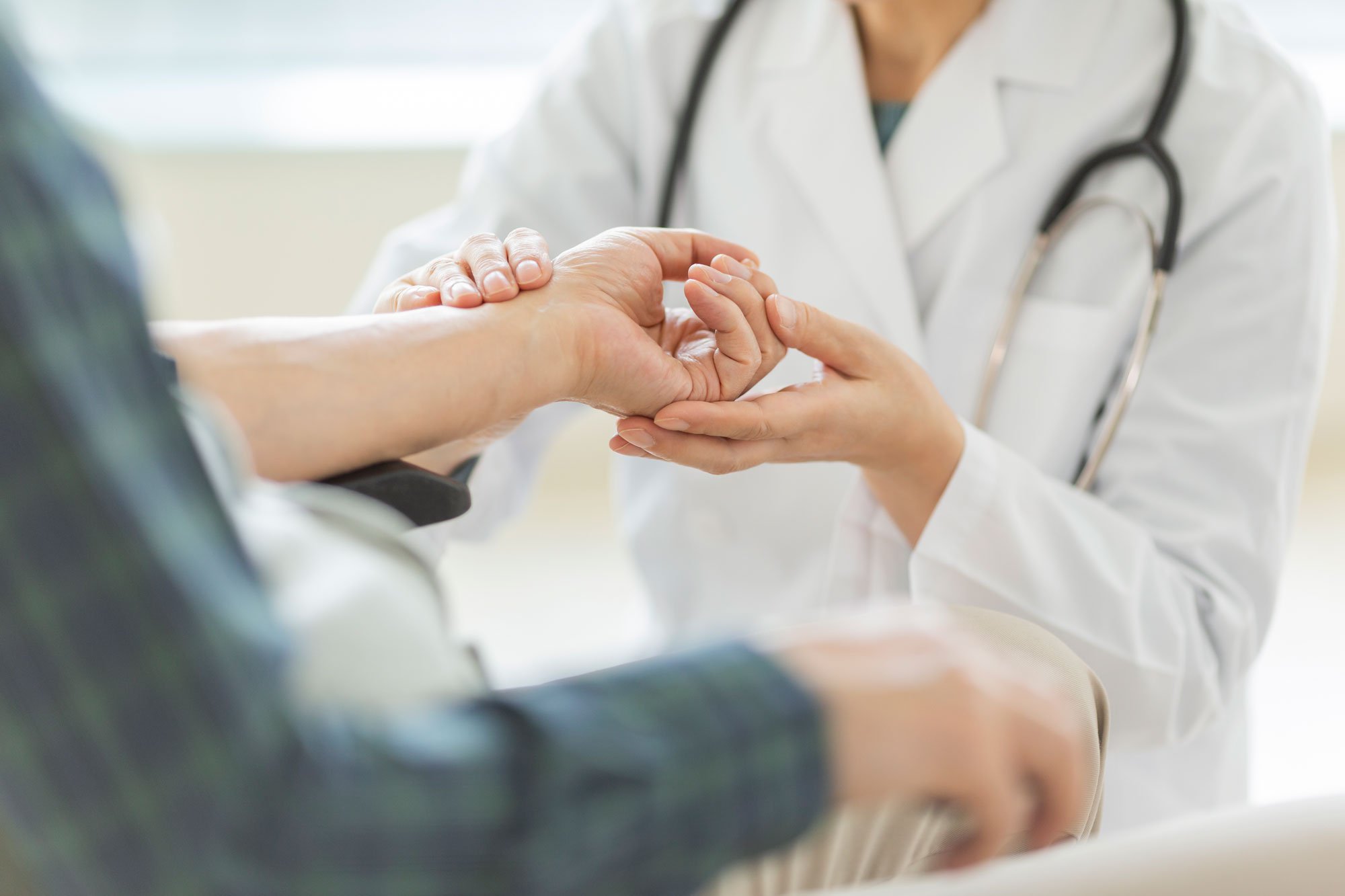 doctor-examining-patient-hand.jpg