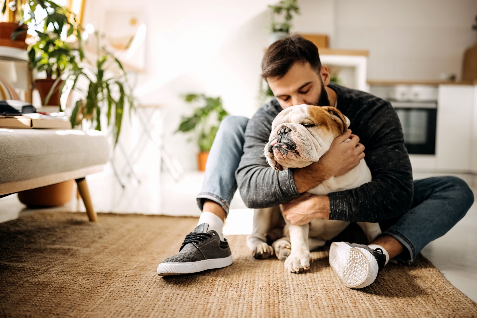 Man hugging emotional support dog