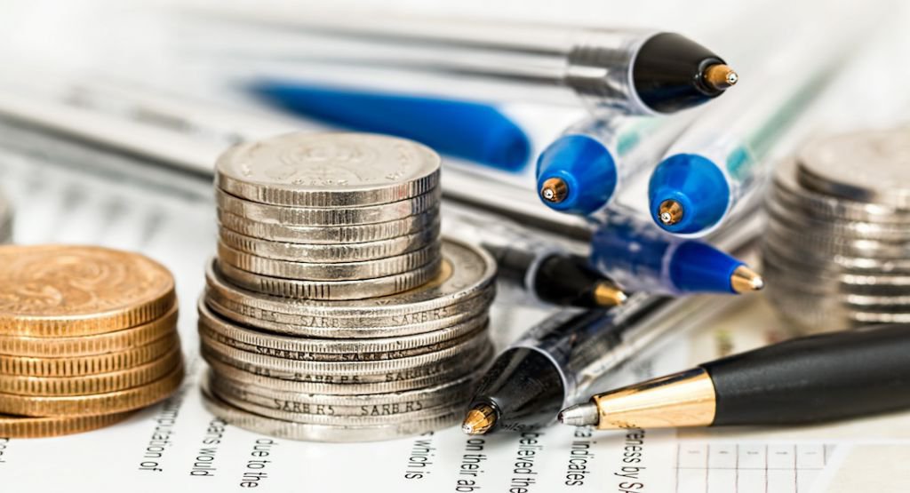 Pile of coins and pens